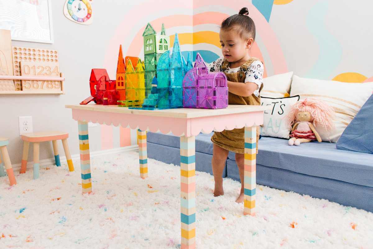 Little girl building with Magna-Tiles