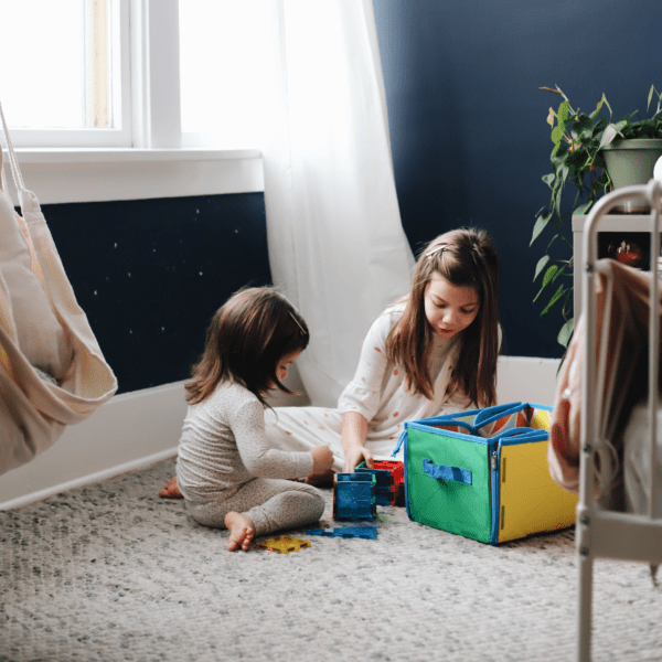 Two young girls playings with MAGNA-TILES® from their Storage Bin