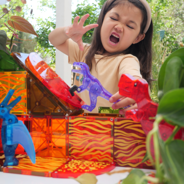 Young girl playing with MAGNA-TILES® Dino World 40-Piece Set