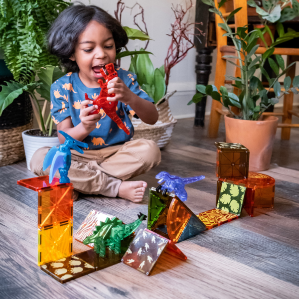 Young boy playing with MAGNA-TILES® Dino World 40-Piece Set