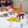 Chicken sitting on cow by a barn using the MAGNA-TILES® Farm Animals 25-Piece Set