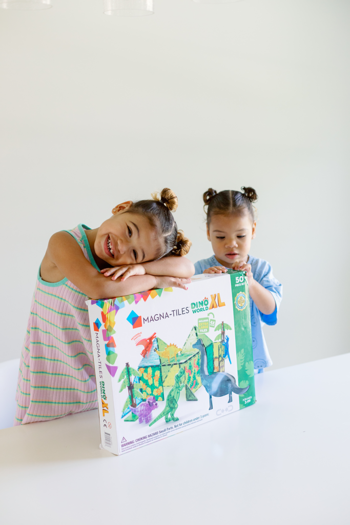 Young children with a box of Magna-Tiles.