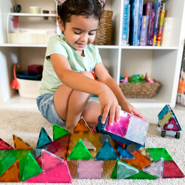 Child playing with MAGNA-TILES Grand Prix Set